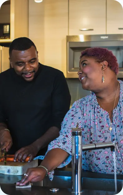 A man and woman are preparing a meal together in the kitchen